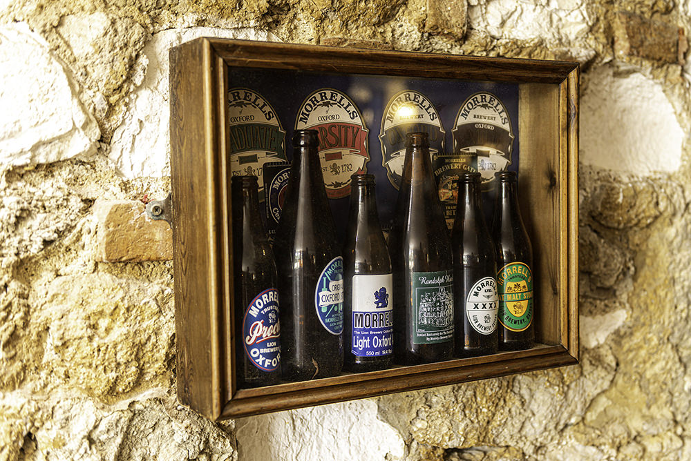 a bootle cabinet displaying some old bottles 
